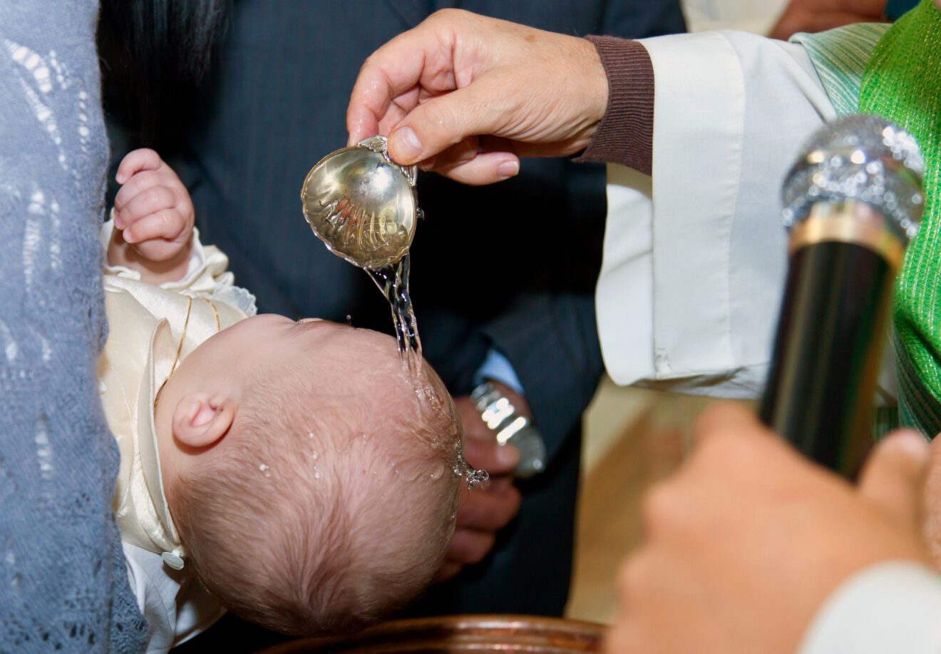 Priest,Pouring,Water,On,A,Baby's,Head,During,A,Baptism